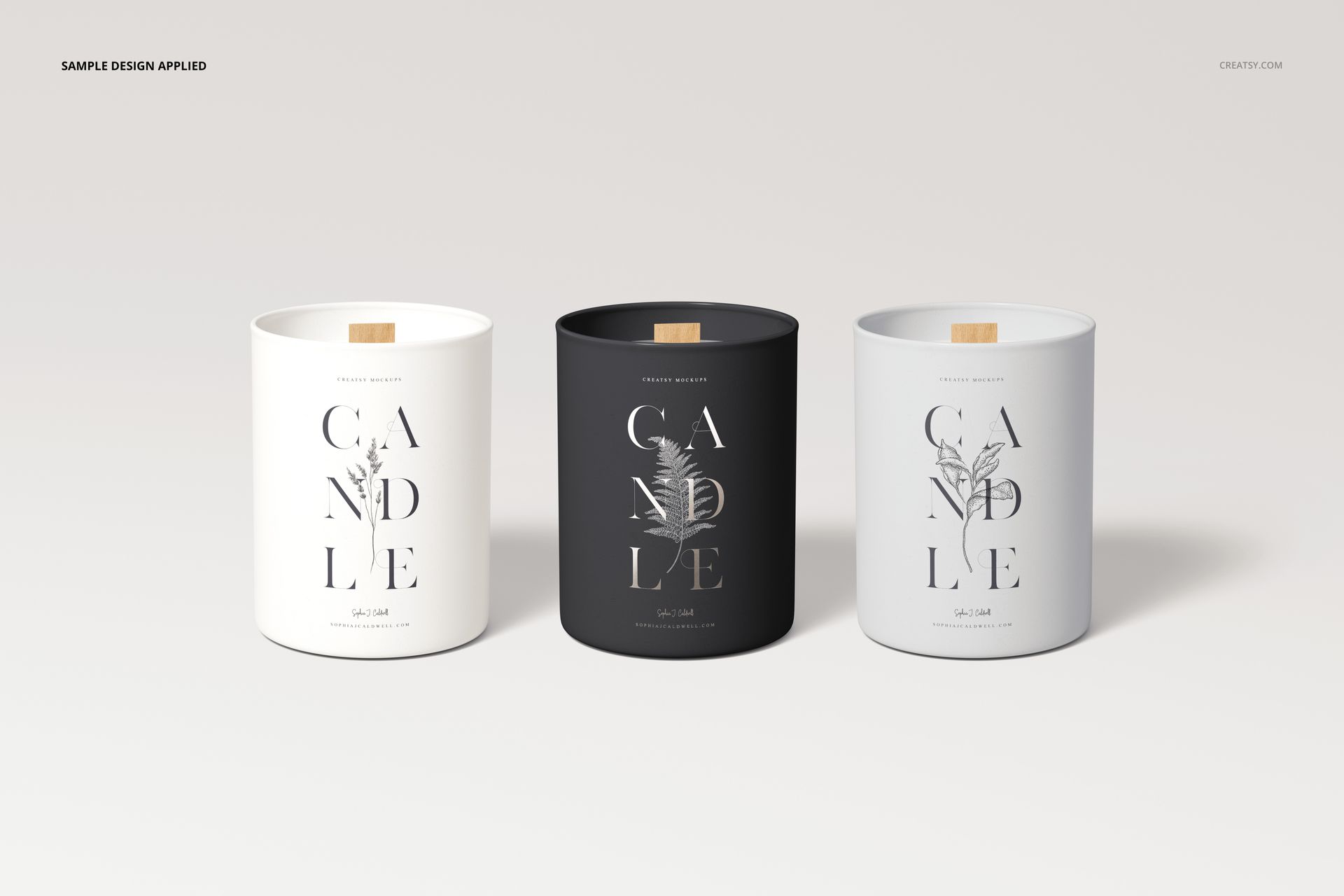 Three wooden wick candle mockups in matte white, black, and gray vessels, arranged side by side on a light surface.
