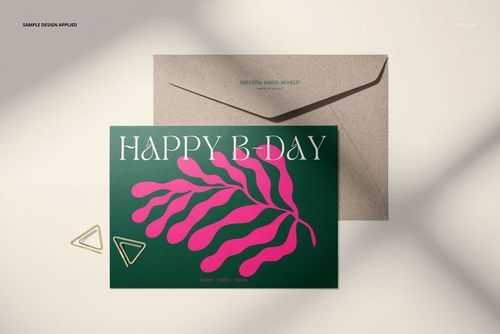 Greeting card mockup featuring a green card with pink botanical artwork and white lettering, shown with a kraft envelope.