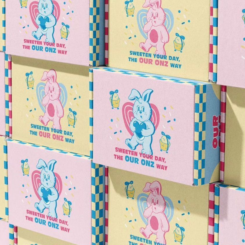 Multiple mailing box mockups arranged in a grid, decorated with playful bunny illustrations and colorful checkered edges.
