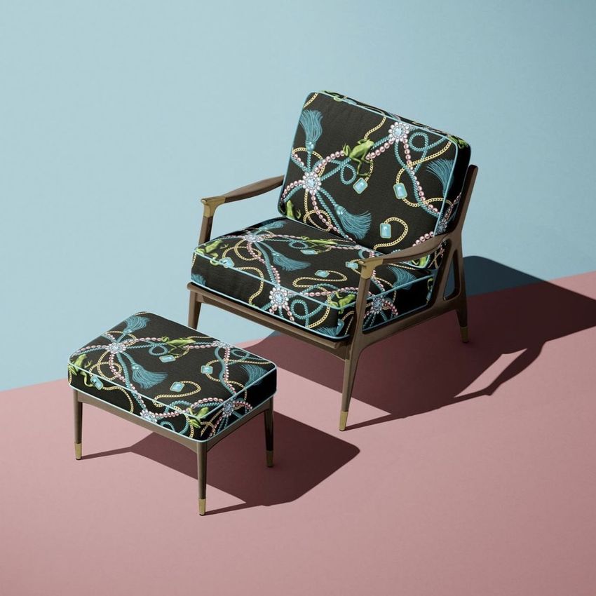 Lounge chair and ottoman mockup set with dark cushions featuring a colorful abstract pattern, shown on a two-tone backdrop.