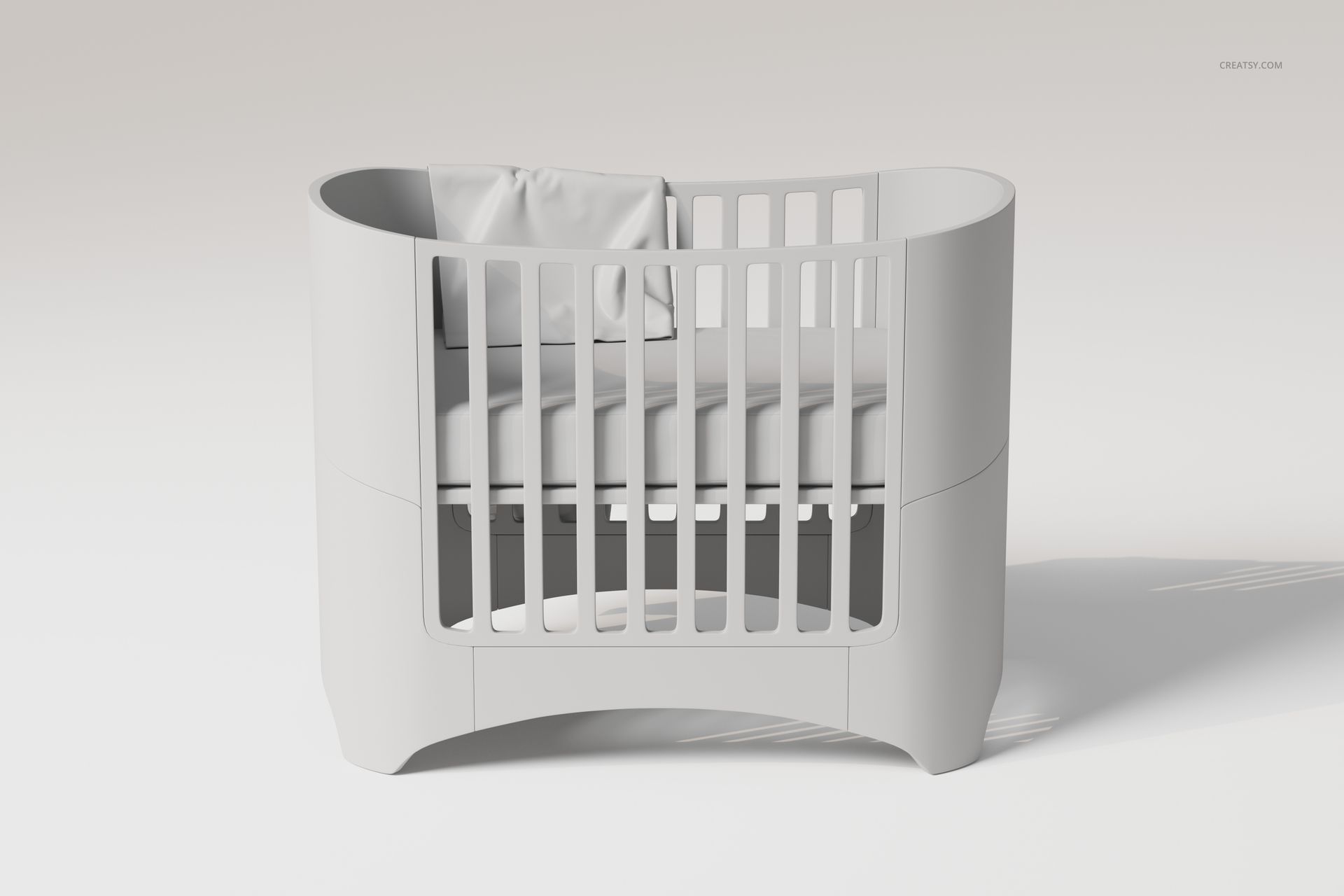 Modern crib with rounded edges in light gray, featuring a large baby blanket draped over the mattress, front view.