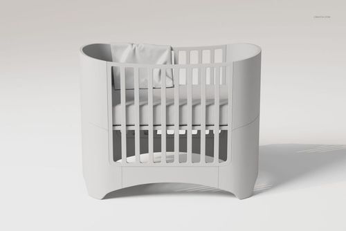 Modern crib with rounded edges in light gray, featuring a large baby blanket draped over the mattress, front view.