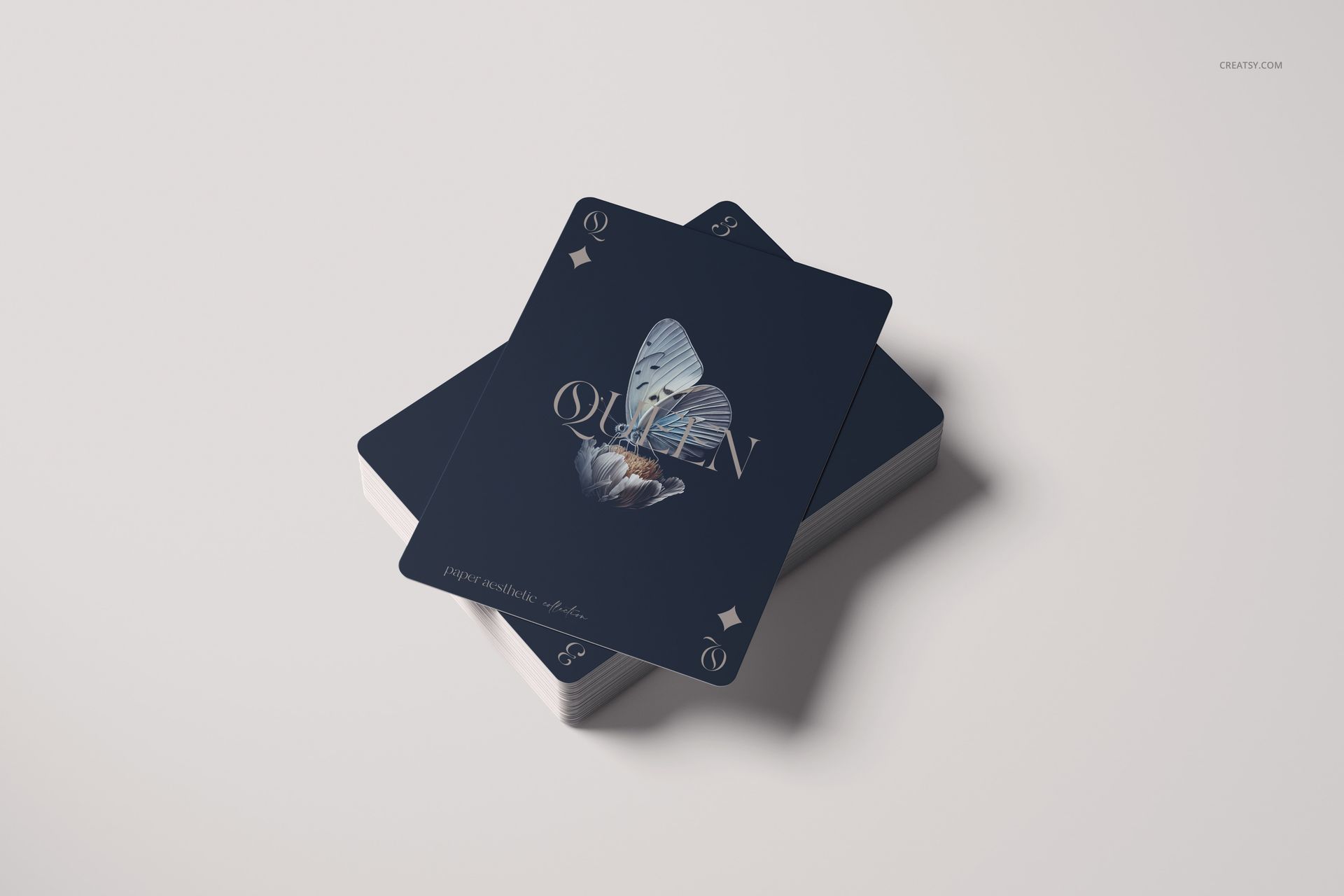 Playing cards mockup with a deck and two cards displayed on top, showcasing a butterfly illustration, top angle.