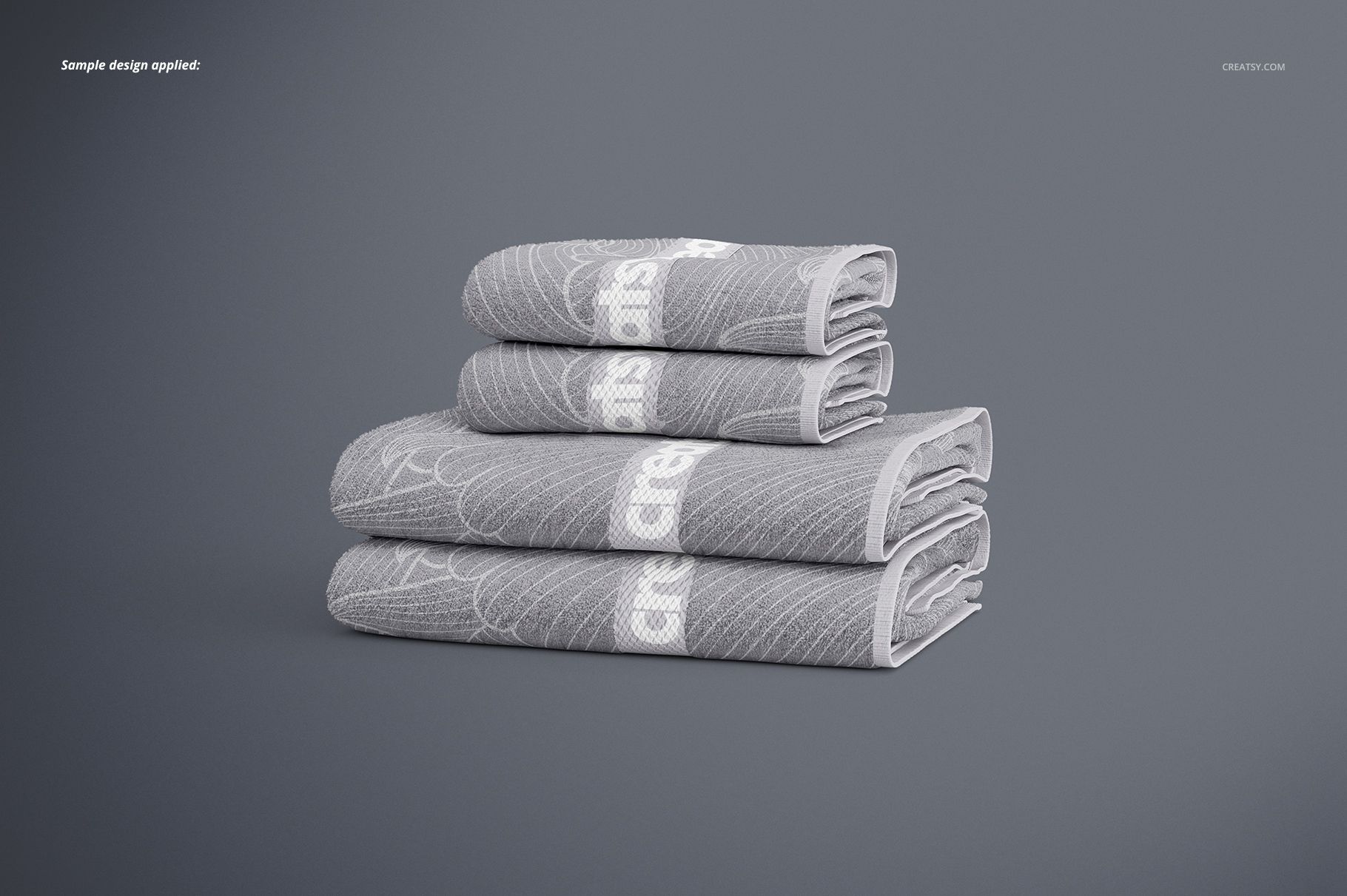 Stack of four gray bath towels with white geometric patterns, displayed on a plain surface in a front view mockup.