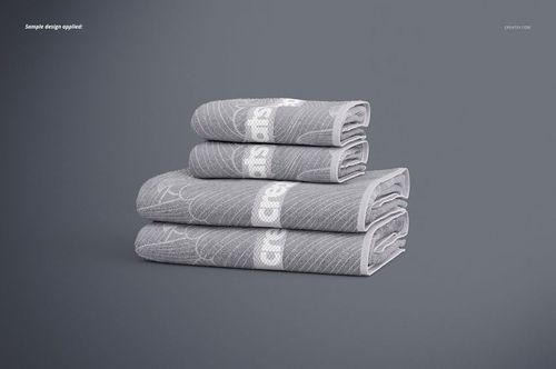 Stack of four gray bath towels with white geometric patterns, displayed on a plain surface in a front view mockup.