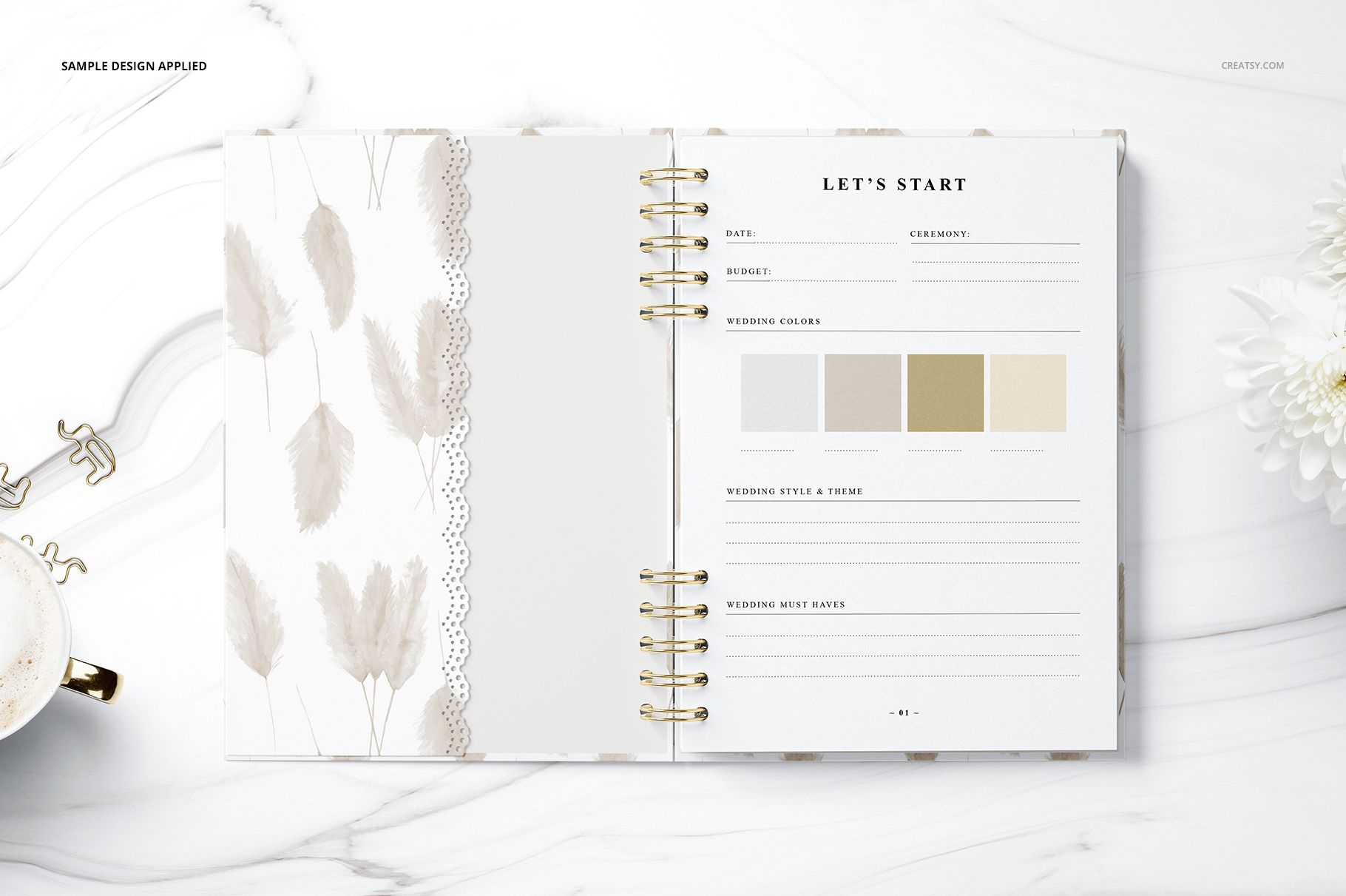 Stationery mockup showing an open planner with beige feather motif and organized wedding planning sections in top view.