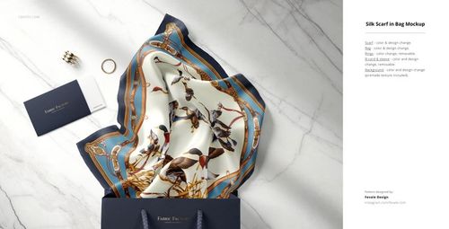 PSD mockup of a silk fabric with colorful bird illustrations, placed in a blue paper bag on a light surface, top-down angle.