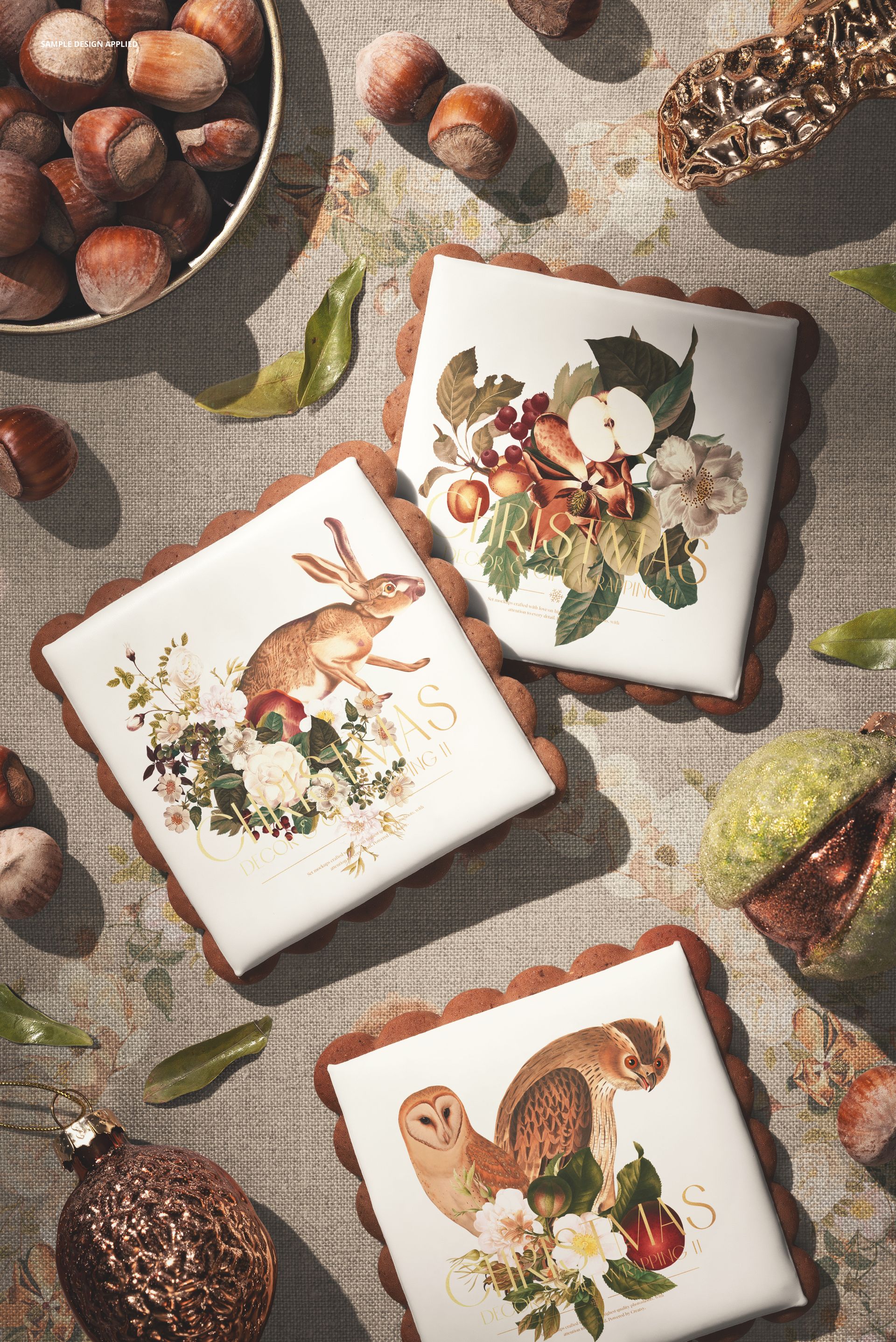 PSD mockup showing three decorated gingerbread cookies on a textured surface with nuts, leaves, and ornaments.