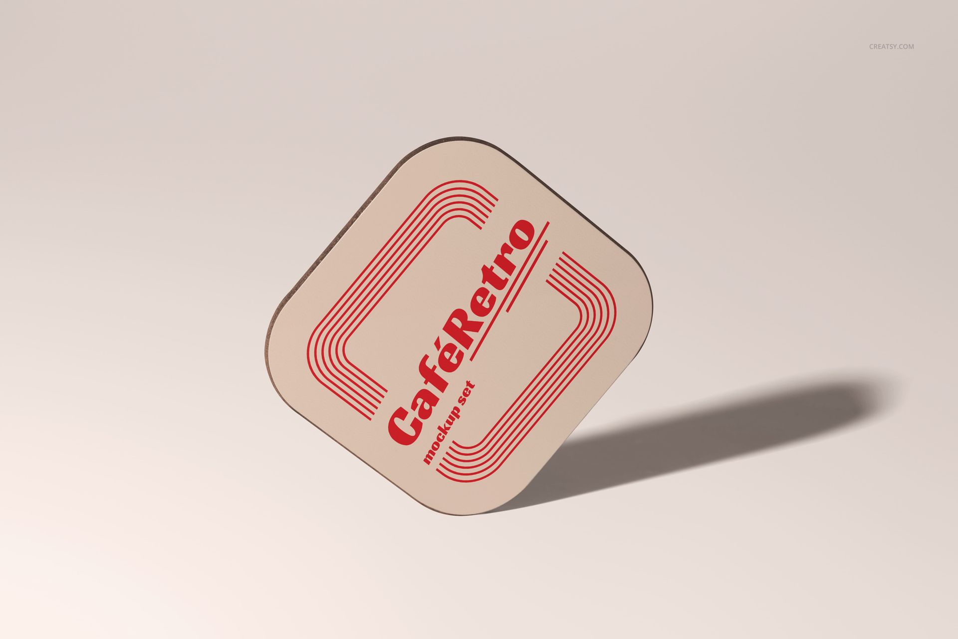 Single square wooden coaster mockup featuring a beige base, red geometric lines, and vintage text, shown at a tilted angle.