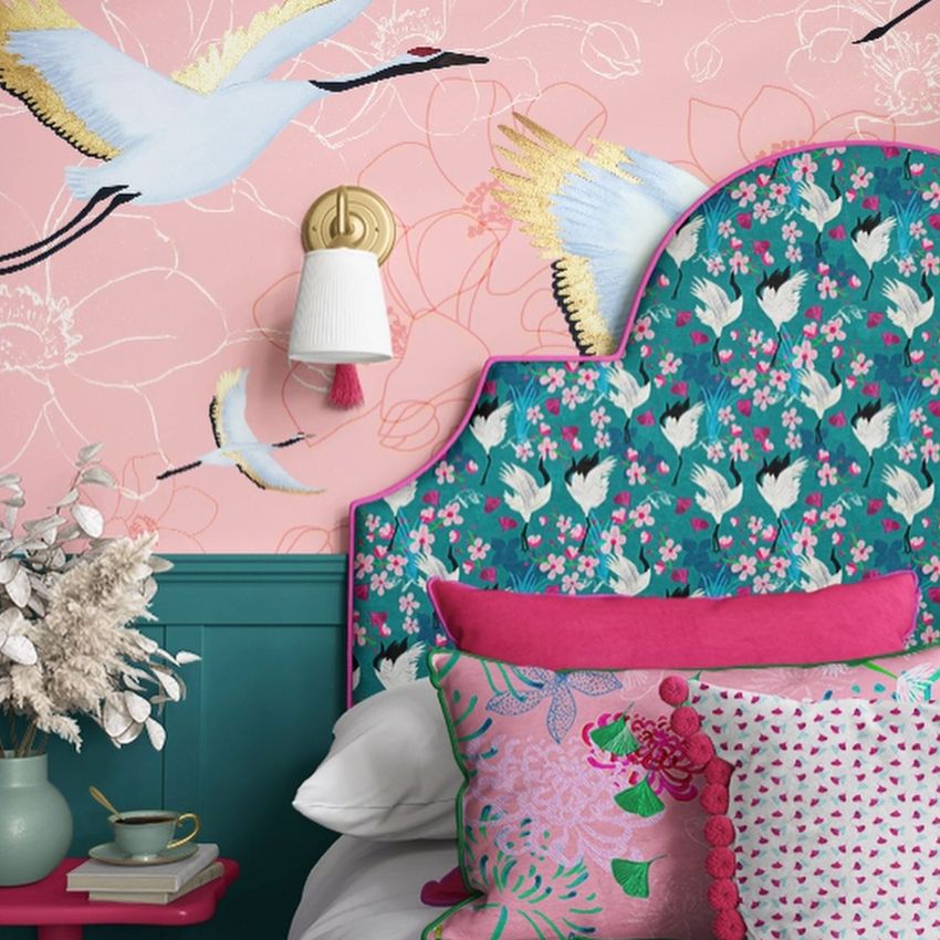 Bedroom pillows, a patterned headboard, and wallpaper mockup featuring crane birds and floral designs in pastel colors.