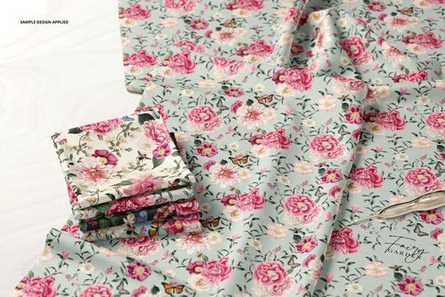 PSD mockup showing multiple folded fabric samples and an unfolded piece, all with a pastel floral print design.