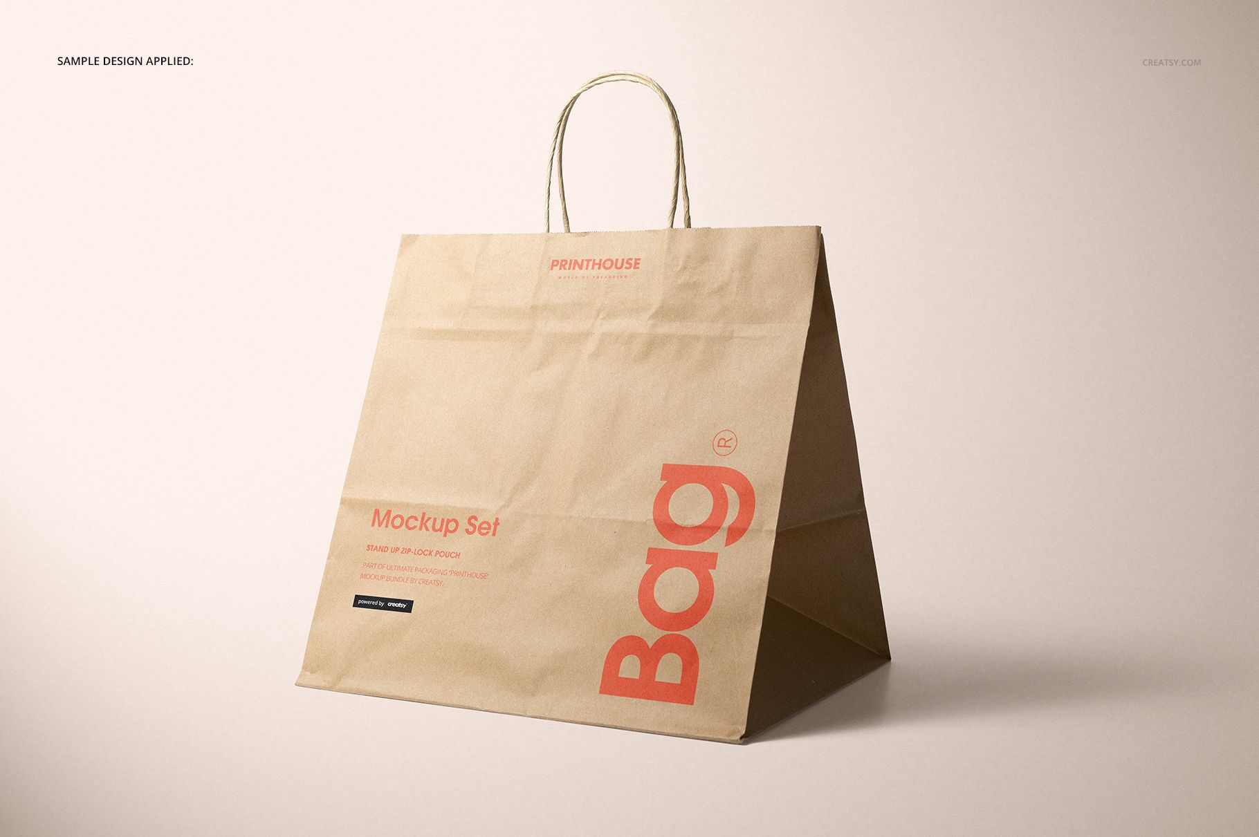 PSD mockup of a large kraft paper shopping bag with visible handles, displayed at an angle on a light surface.