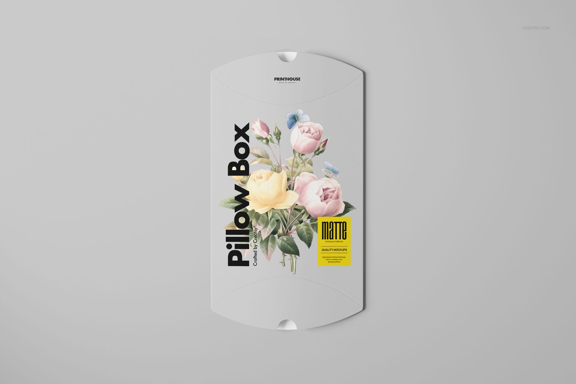 Matte pillow box mockup featuring soft pink and yellow flowers, bold black lettering, and a yellow accent label.