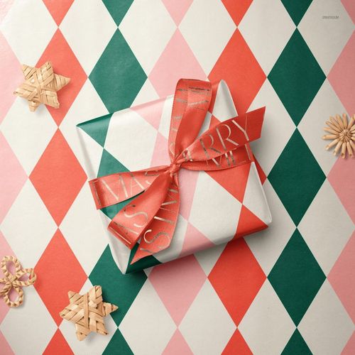 Festive PSD mockup showing a wrapped gift box with red and green diamond pattern, surrounded by straw ornaments.