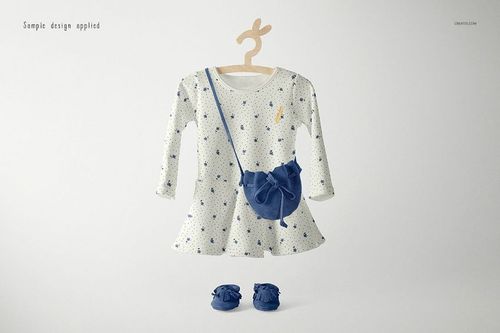 Long-sleeve baby dress mockup with a white base and blue star pattern, displayed with matching blue bag and shoes.