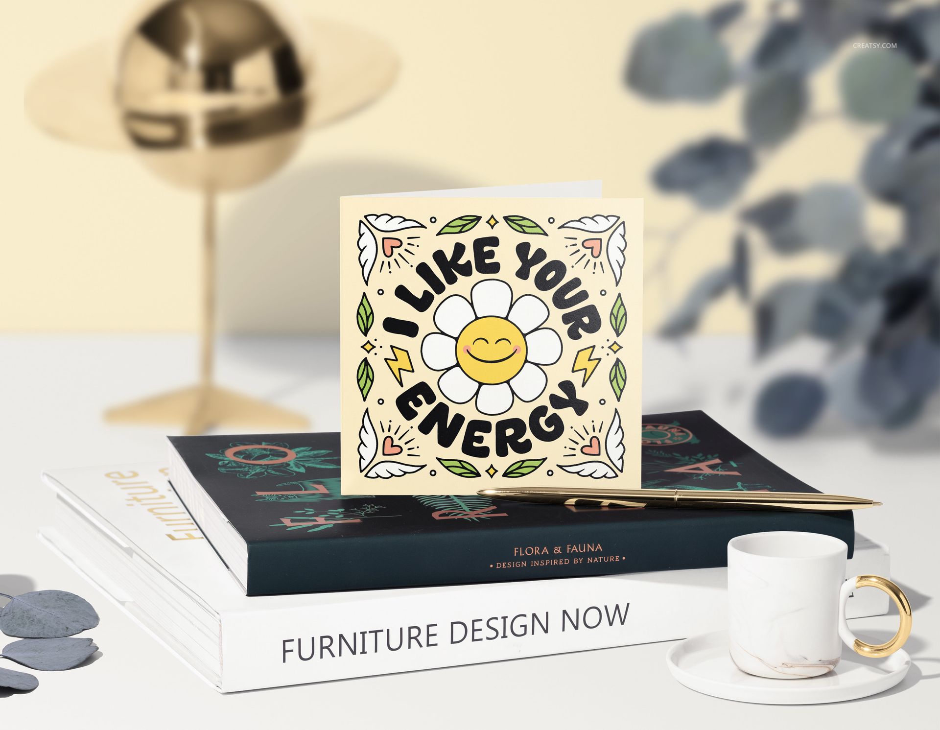 Front view of a square greeting card mockup featuring a colorful flower pattern and positive message, placed on books.