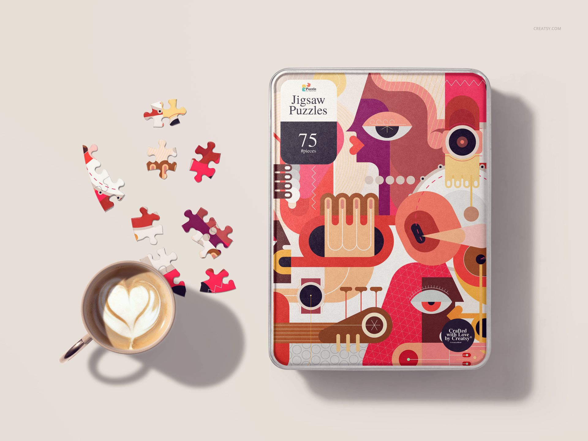 Heart-shaped jigsaw puzzle mockup with abstract colorful design, shown in a metal tin next to loose pieces and a coffee cup.