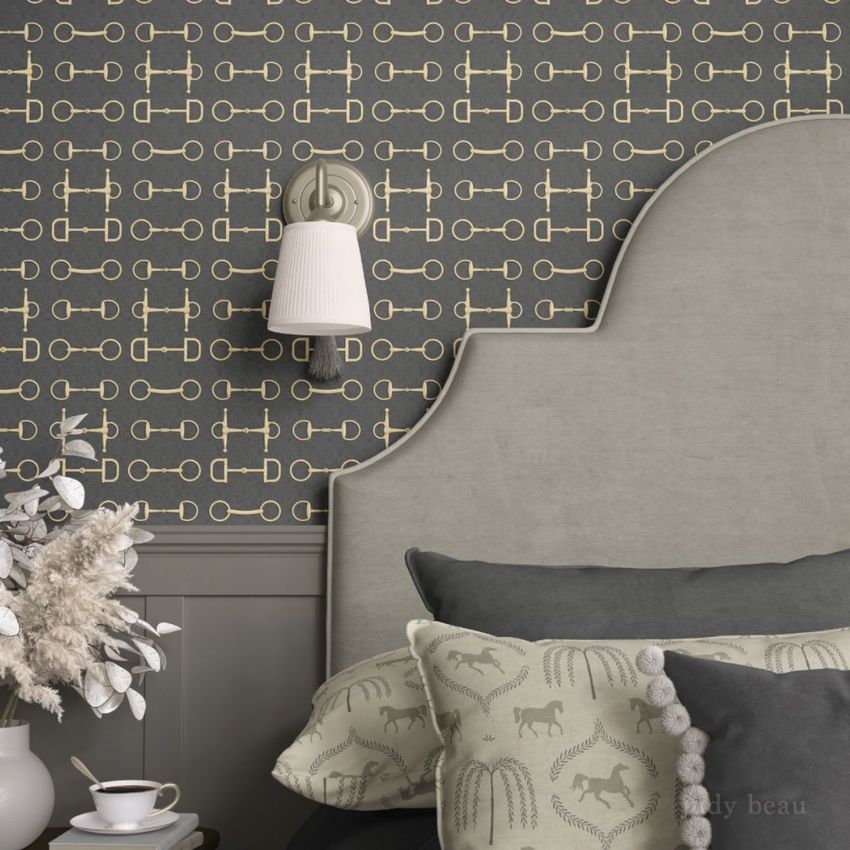 Bedroom pillows and headboard mockup featuring a patterned wallpaper with gold snaffle designs, soft gray tones, and a wall sconce.