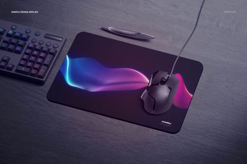 Rectangular gaming mouse pad mockup with rounded corners, featuring a colorful wave pattern on a dark desk surface.