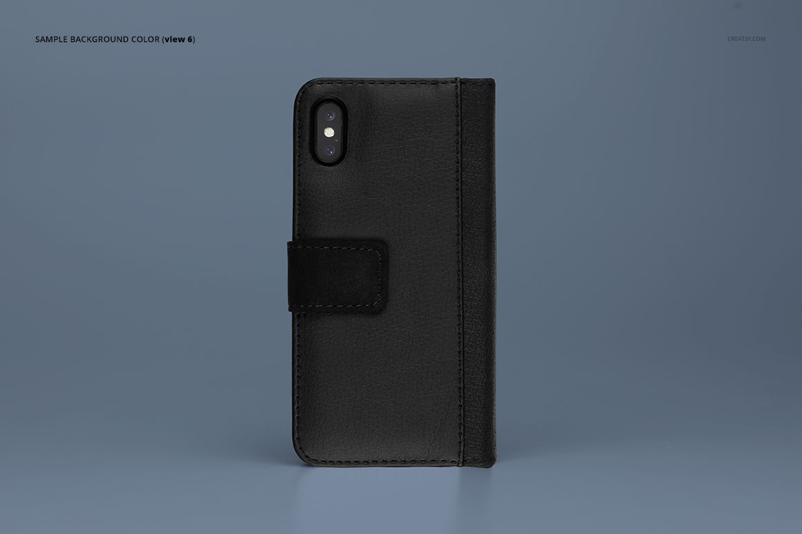 PSD mockup of a black iPhone X foldable case with visible stitching, photographed on a smooth blue surface.
