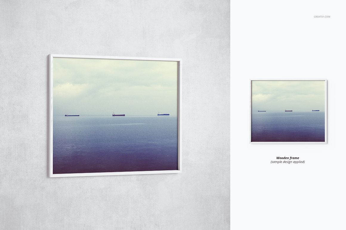 Front view of a thin white picture frame mockup displaying a seascape with ships, set against a light gray wall.
