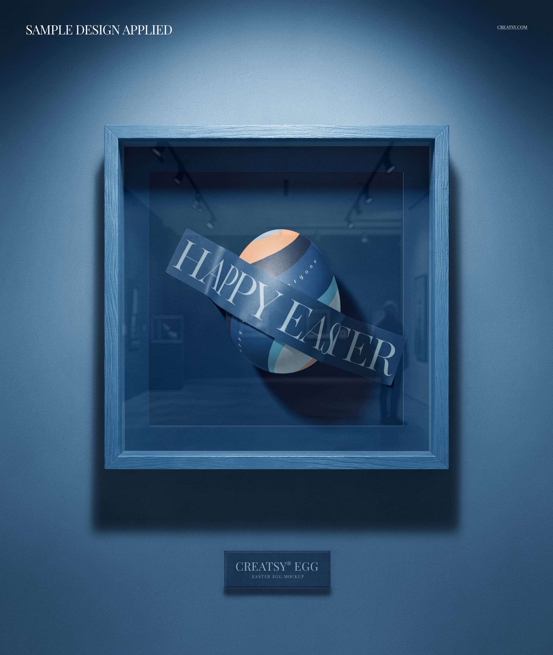 Framed Easter egg mockup with geometric pastel patterns and Happy Easter text, shown in a blue shadow box frame.