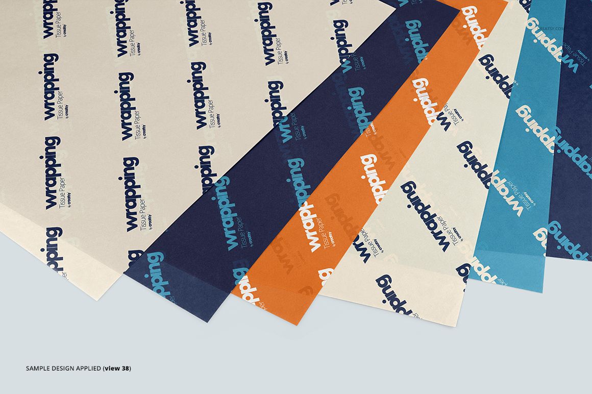 Several sheets of wrapping tissue paper mockup displayed in a layered arrangement with blue, orange, and cream colors.
