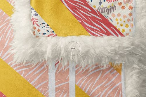 Detailed top view of a sherpa baby blanket mockup showing soft white sherpa edge and vibrant geometric designs.