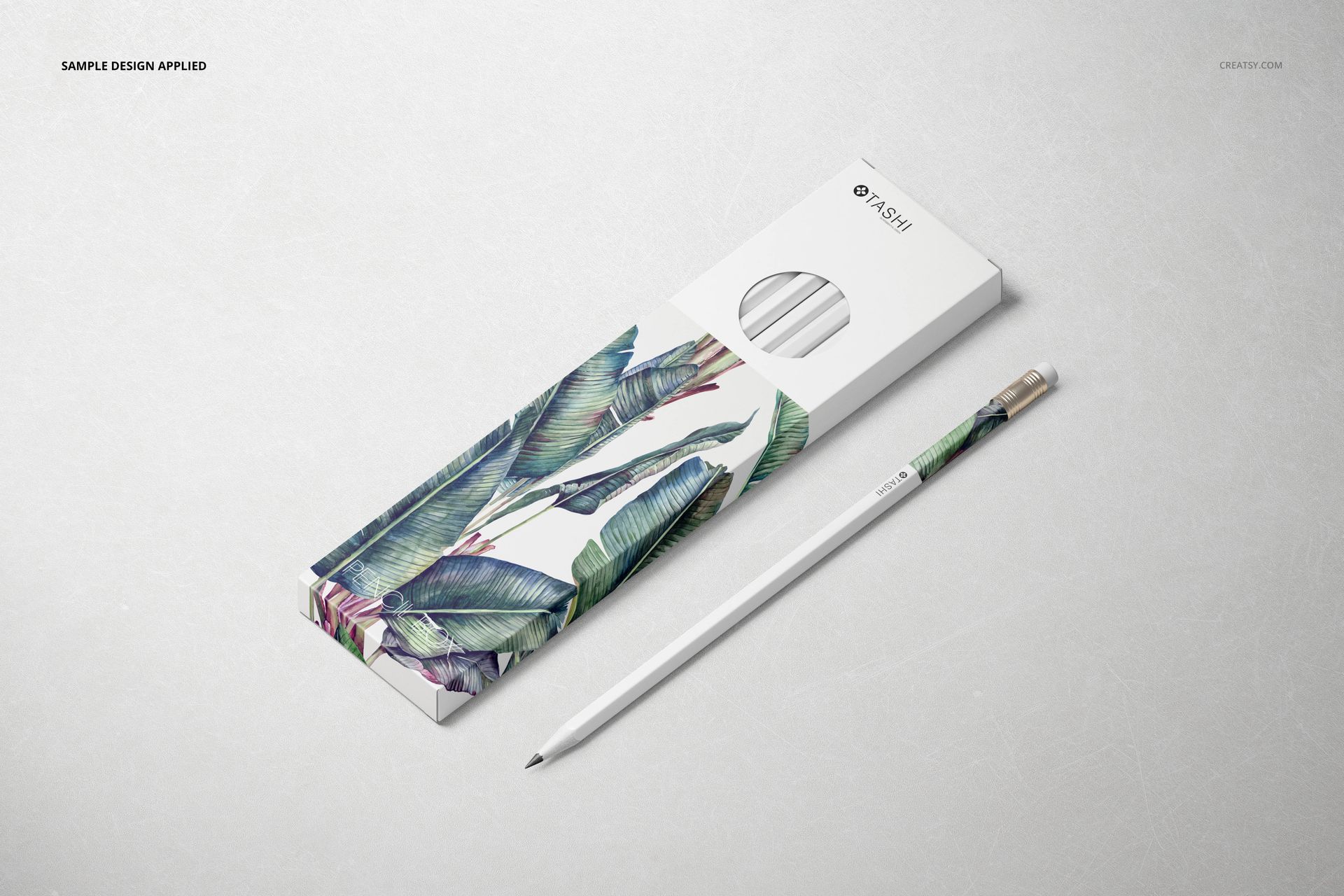 Pencil box mockup featuring green leaf design, shown with coordinating pencil on a neutral background, top perspective.