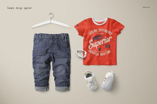 Baby T-shirt mockup set showing a red short-sleeve shirt with printed text, denim pants, shoes, and a bracelet on a beige background.