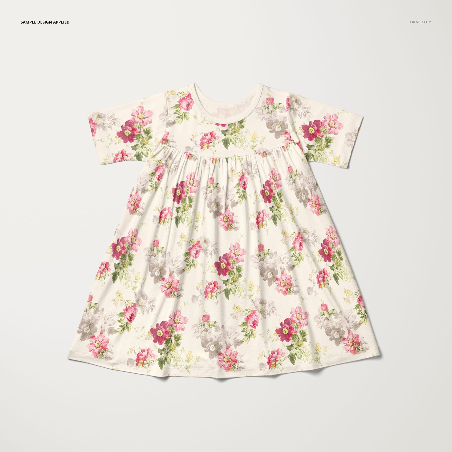 Kids swing dress mockup featuring a soft floral design in pink and gray, shown from above on a neutral surface.