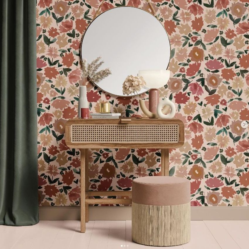 Dressing table mockup featuring a wooden vanity with a round mirror, floral wallpaper, and decorative vases and lamp.