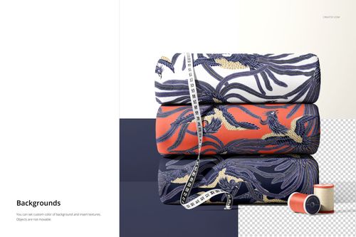 Stack of scuba fabric mockup rolls featuring intricate leaf and bird designs in blue, white, and orange tones.