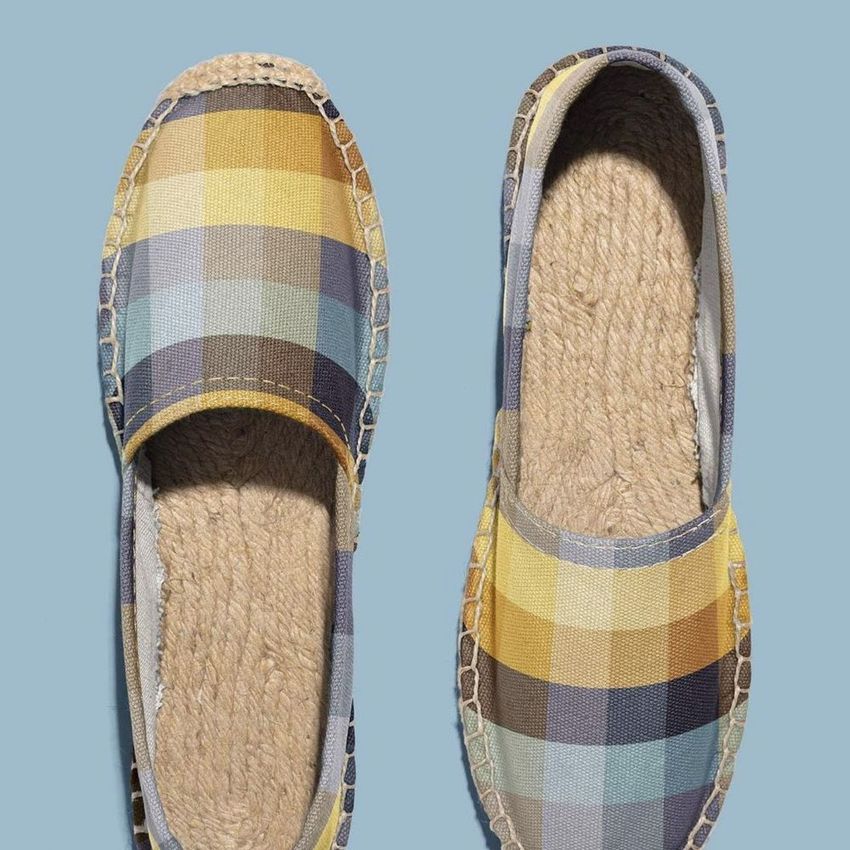 Canvas espadrilles mockup featuring a pair of shoes with a yellow, blue, and brown plaid pattern on a light blue background.