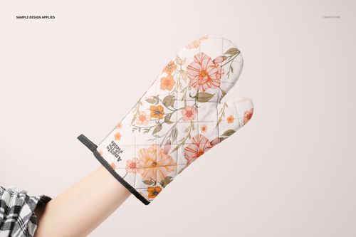 Floral patterned oven mitt mockup shown from a side view, held by a hand against a light background.