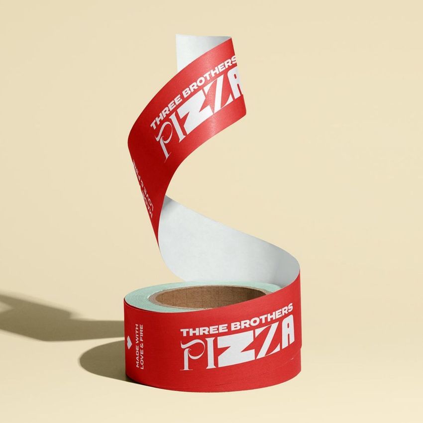 Packaging tape mockup featuring a roll of red tape with bold white text, unspooled in a spiral on a beige background.