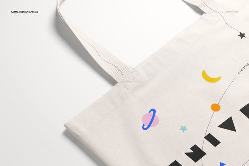 Close-up of a weekender tote bag mockup displaying playful planets and stars on a white background.