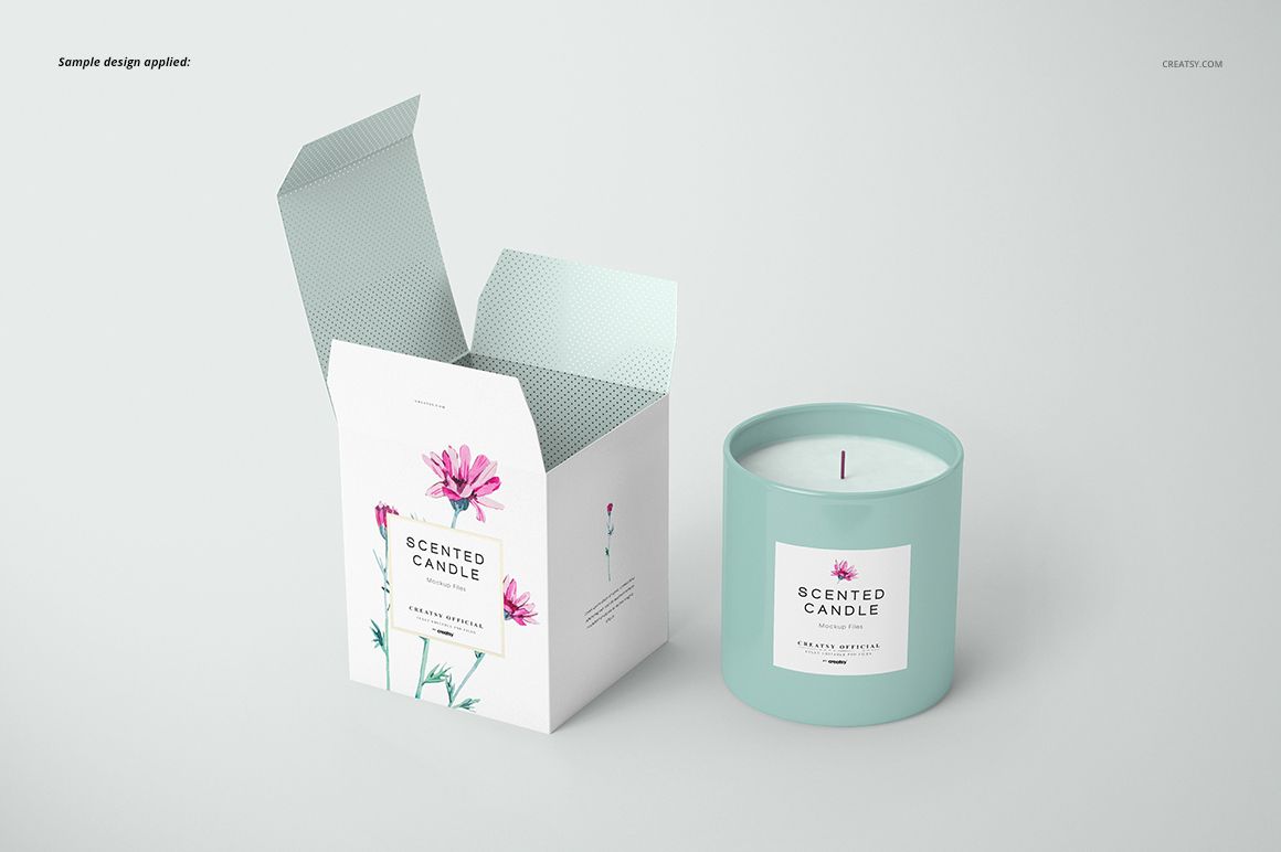 Front view of a classic candle and open box mockup, featuring a light blue candle jar and floral label design on a white background.