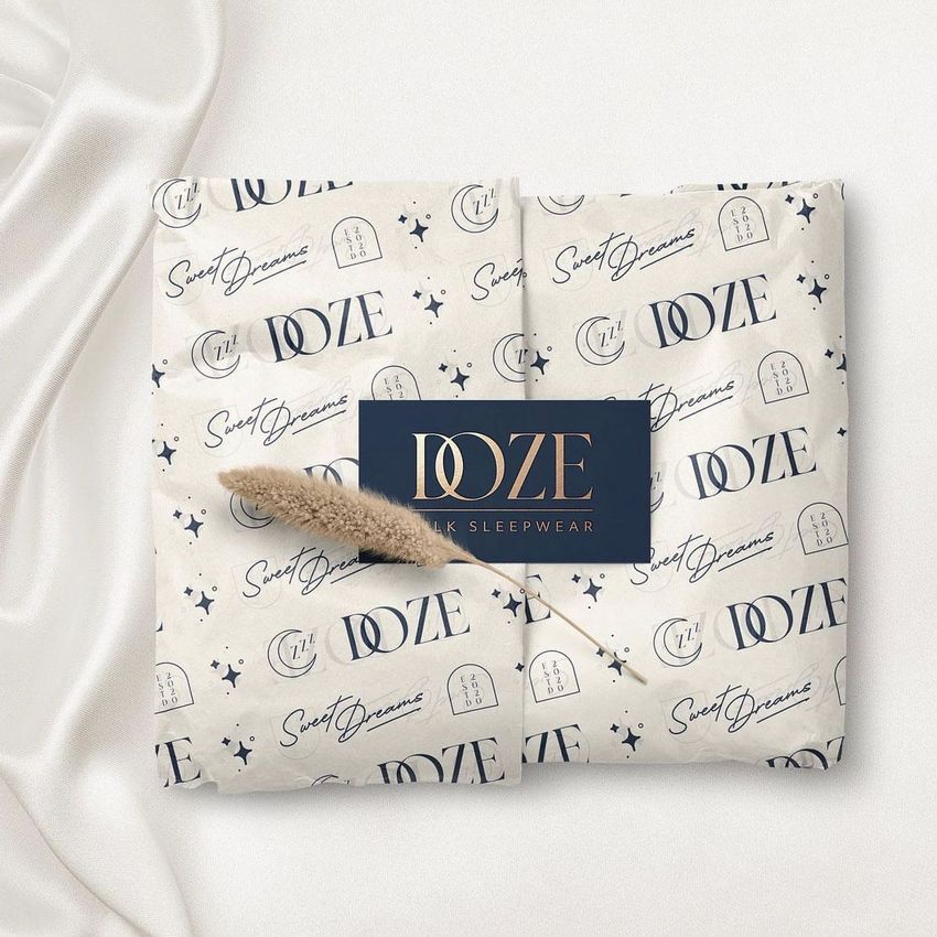 Tissue paper mockup featuring a repeating pattern of moons, stars, and text, wrapped around a package with a dark label on top.