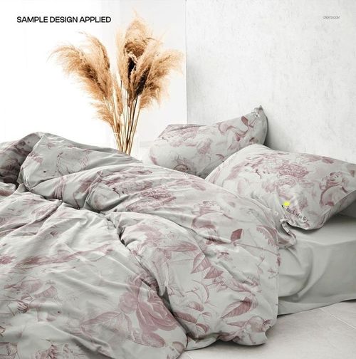 PSD mockup showing a bed with wrinkled duvet cover and pillowcases featuring a delicate floral design in pale tones.