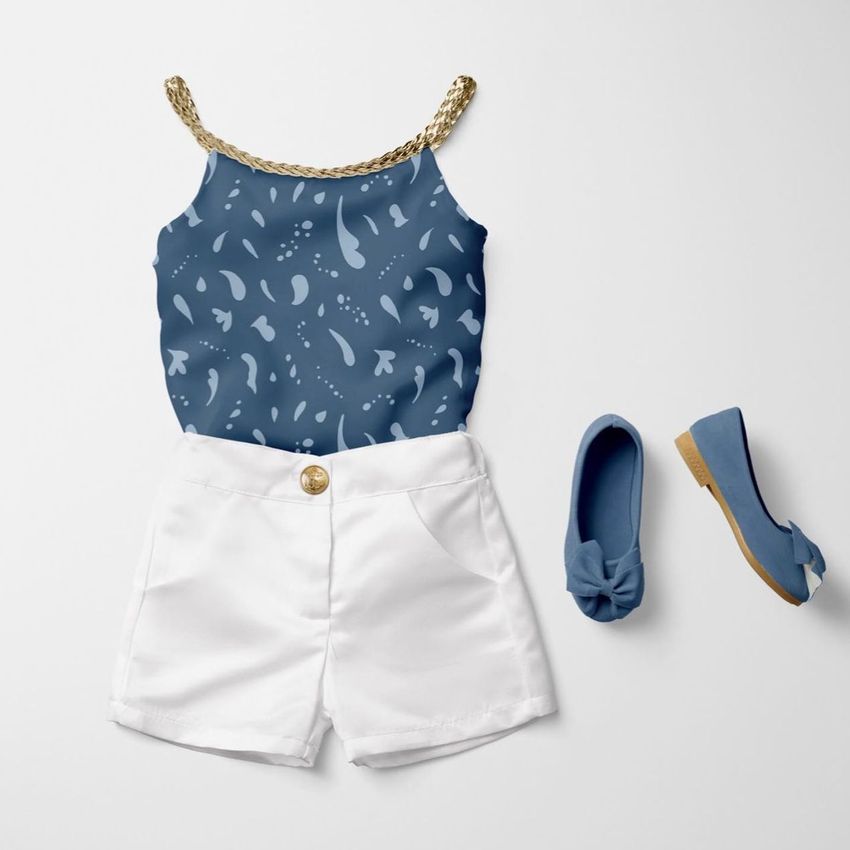 Kids summer set mockup featuring a blue patterned tank top with gold straps, white shorts, and matching blue shoes on a white background.