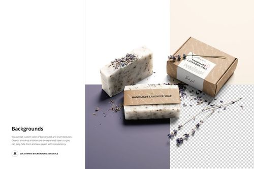 PSD mockup featuring handmade soap bars and a labeled box, displayed with lavender sprigs on a two-tone surface.
