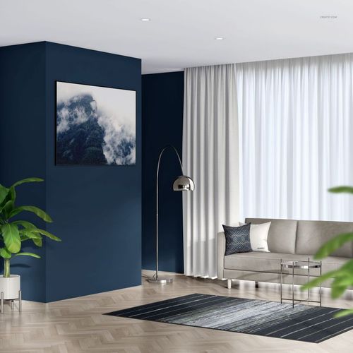 Modern living room with textile frame mockup, featuring a blue accent wall, gray sofa, and large window with sheer curtains.