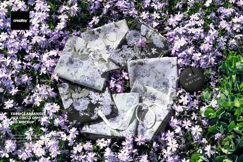 PSD mockup showing various fabrics with detailed floral designs placed in a ring on blooming ground cover.
