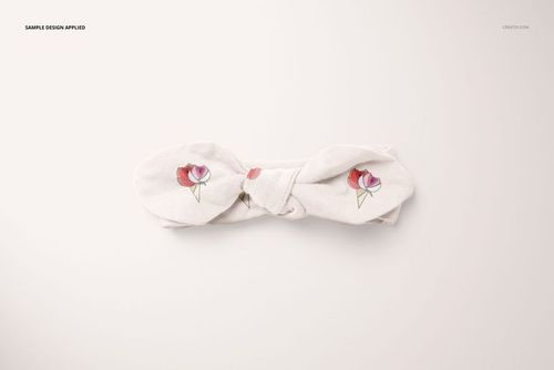 Top view of a baby swaddle headband mockup on a light background, featuring a soft fabric with floral patterns.