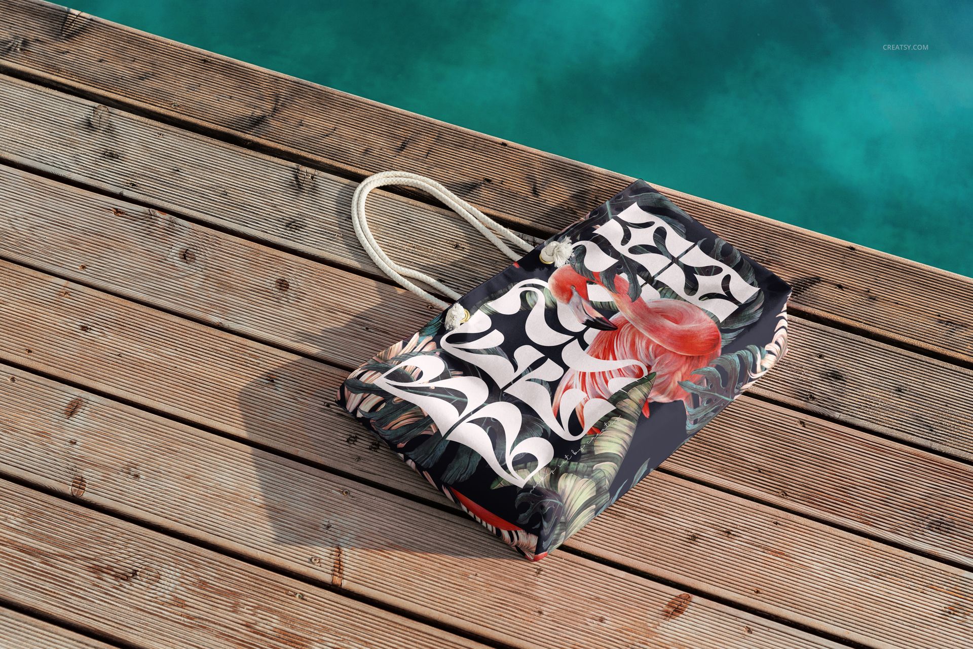 Spun polyester weekender bag mockup displayed on a sunlit wooden dock, showing vivid patterns and summer colors.