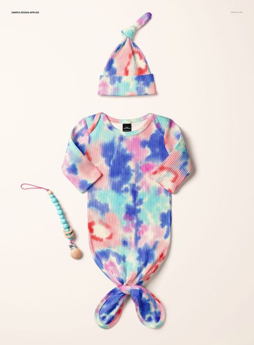 PSD mockup of a baby ribbed gown and hat set featuring vibrant blue, pink, and green tie-dye design, top view.
