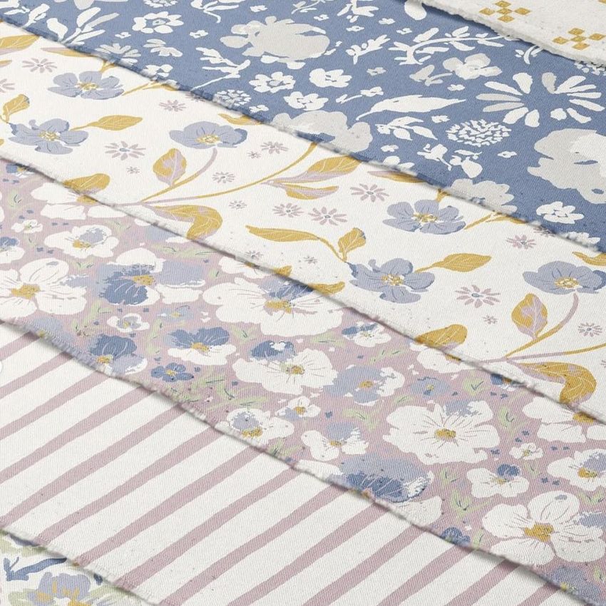 Fanned cotton fabric stack mockup featuring five pieces with floral and striped patterns in blush, blue, and cream tones.