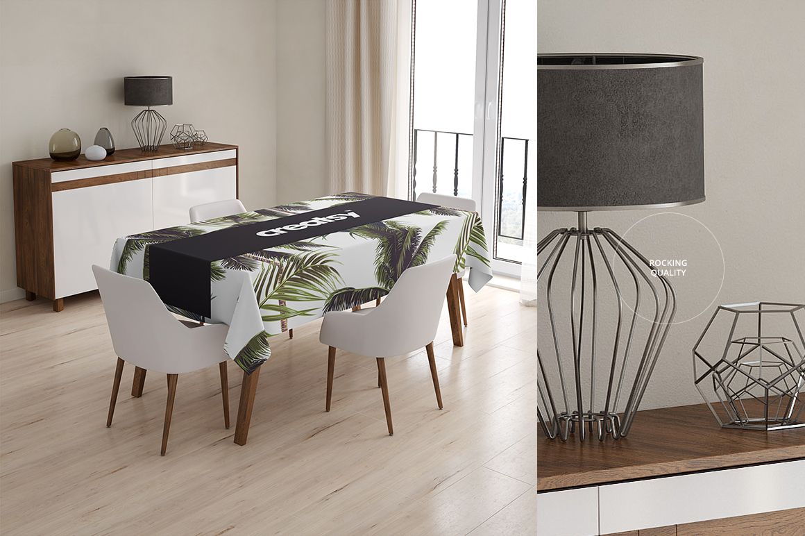 Dining table covered with a PSD mockup tablecloth featuring green palm leaves and a black runner in a bright interior.