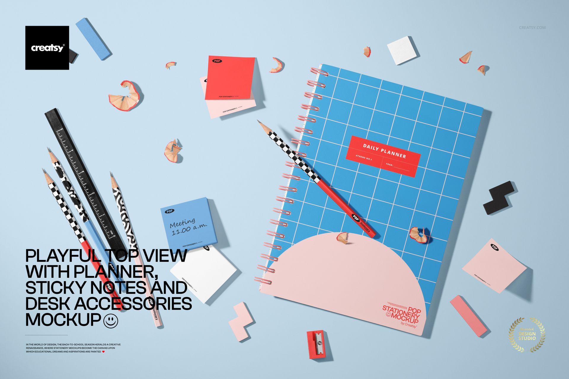 Playful top-down scene featuring a planner, sticky notes, patterned pencils, and small desk props on a blue background, shown as a PSD mockup.
